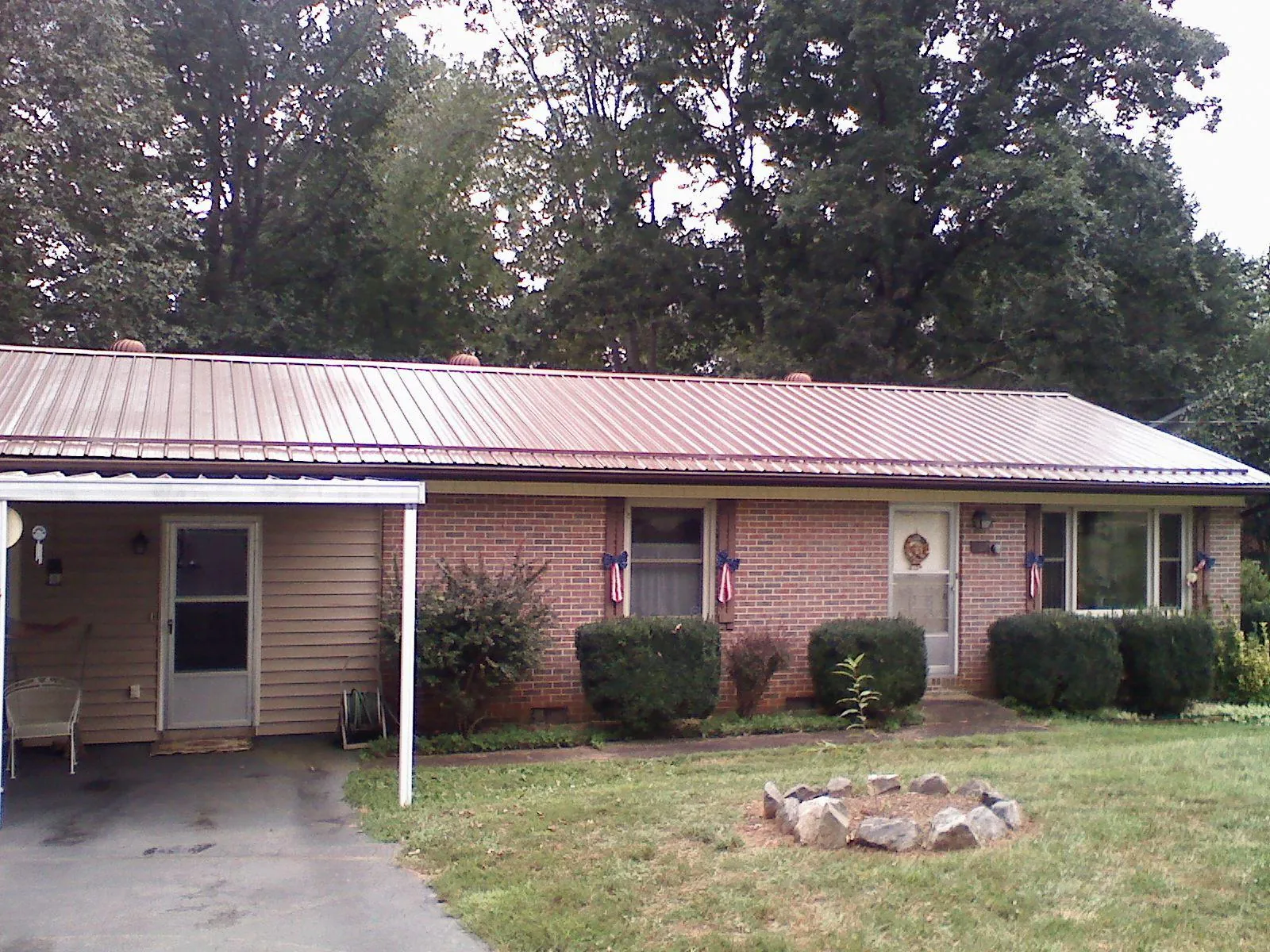Bronze metal roof and carport on a brick ranch home — Roof Repair work by our crew in Antioch